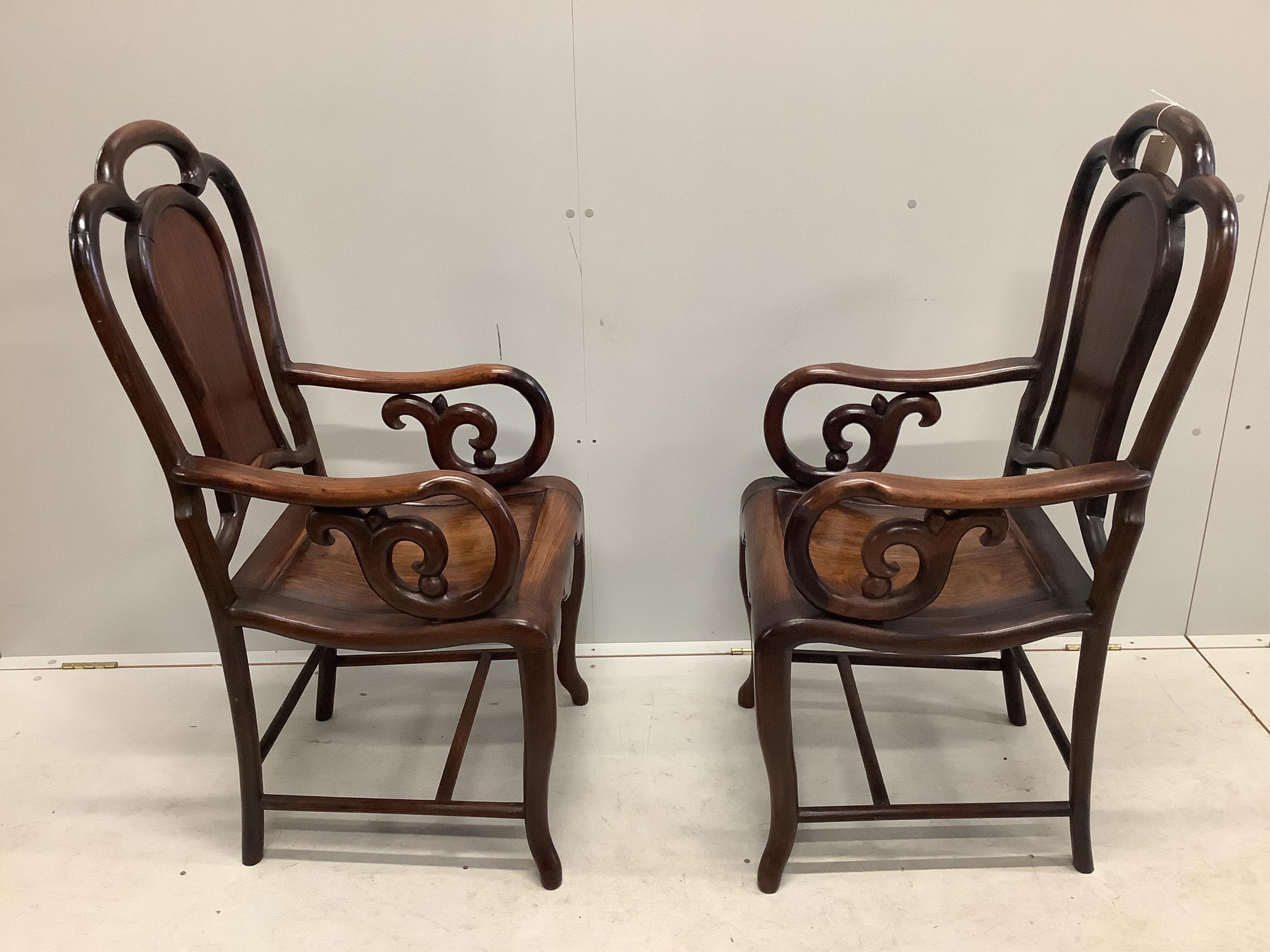 A pair of Chinese hongmu elbow chairs exhibited at British Empire Exhibition Wembley 1924, width 52cm, depth 48cm, height 110cm. Condition - fair to good